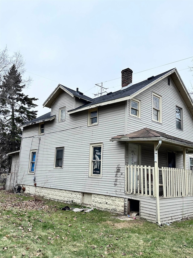 back of house with a lawn