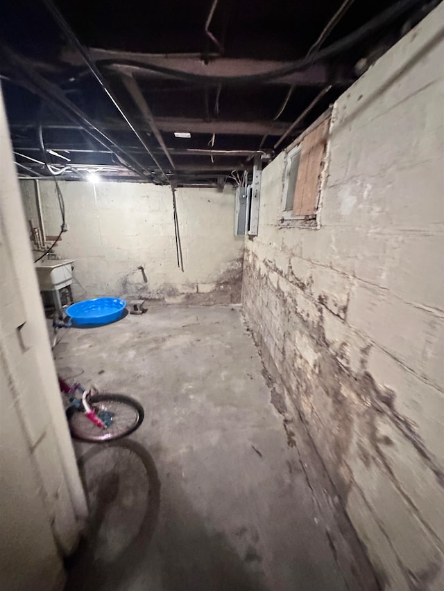 basement with electric panel and sink