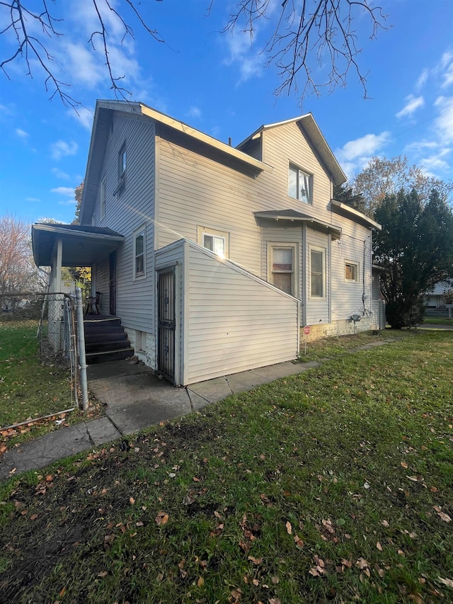 rear view of house featuring a lawn