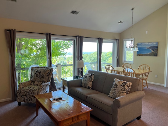 5678 N Crossover Dr Unit 2, Bellaire, MI 49615 - carpeted living area featuring baseboards, vaulted ceiling, and a chandelier