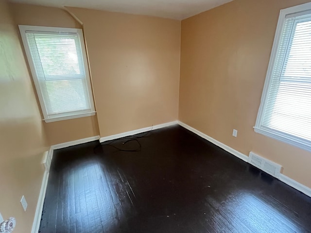 unfurnished room with hardwood / wood-style flooring