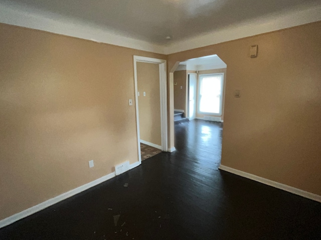 spare room with dark hardwood / wood-style flooring