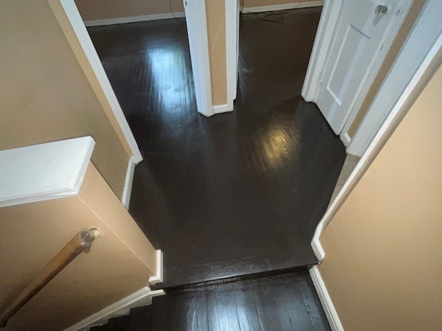 stairs featuring hardwood / wood-style floors