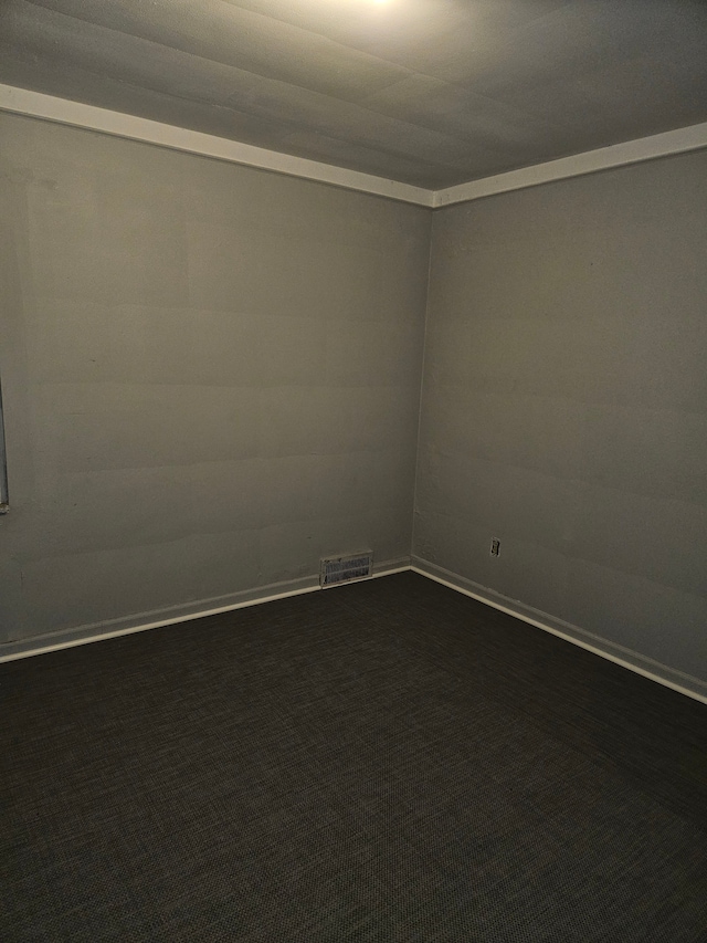 empty room with dark carpet