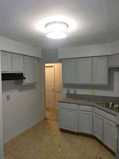 kitchen with gray cabinetry and sink