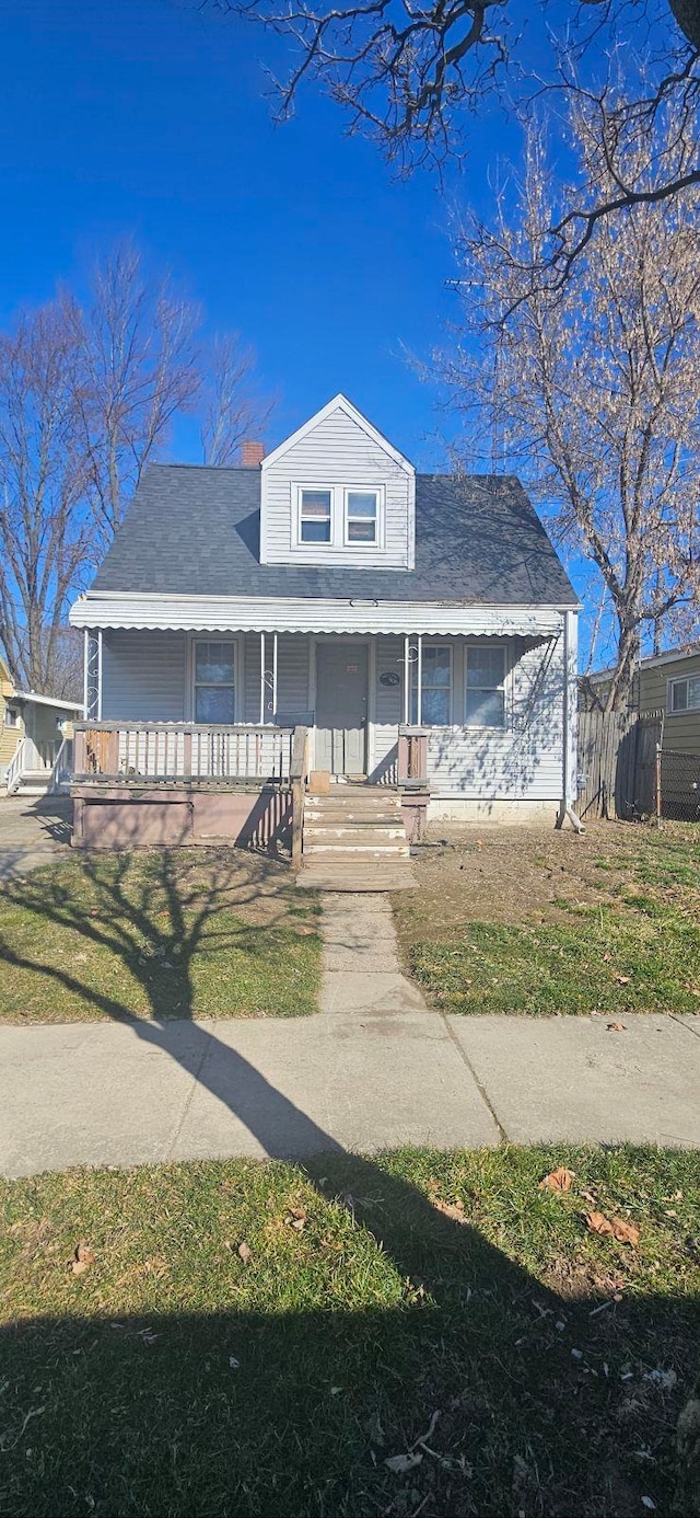 view of front of house featuring covered porch and a front lawn