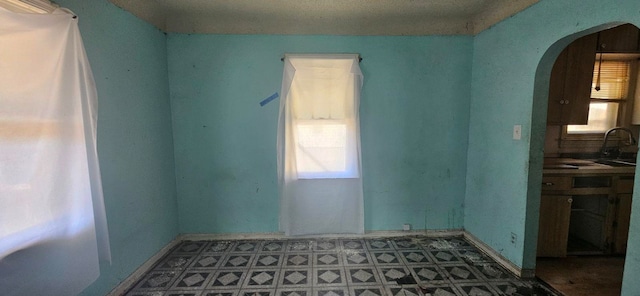 spare room with a textured ceiling and sink