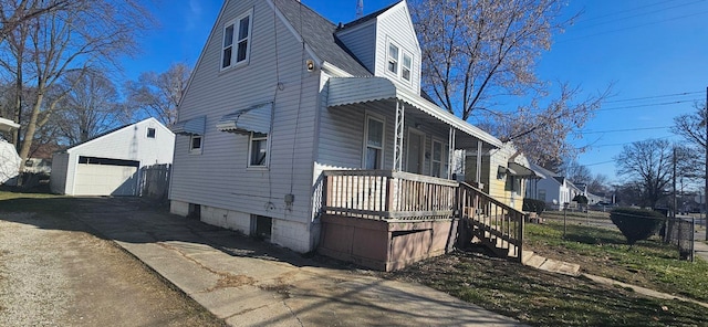 view of side of home with a garage and an outdoor structure