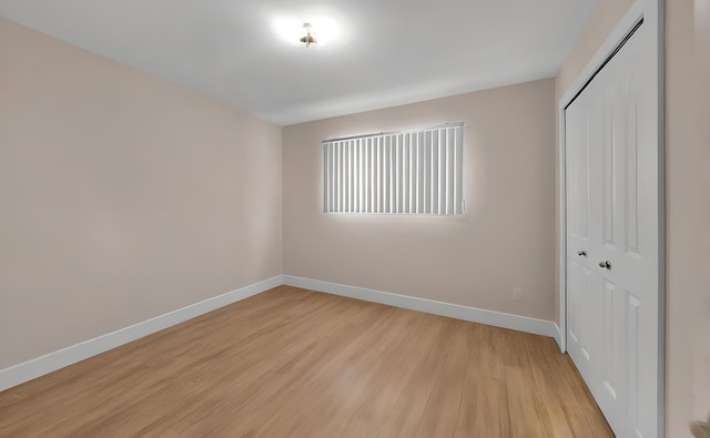 unfurnished bedroom featuring a closet and light hardwood / wood-style flooring