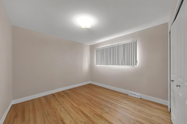 empty room with light hardwood / wood-style floors