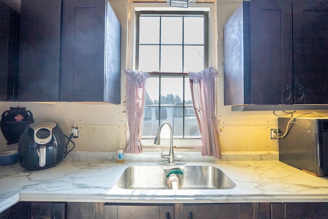 kitchen featuring a healthy amount of sunlight, blue cabinets, and sink