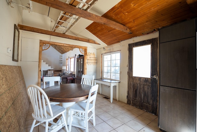 tiled dining room featuring vaulted ceiling and wooden ceiling