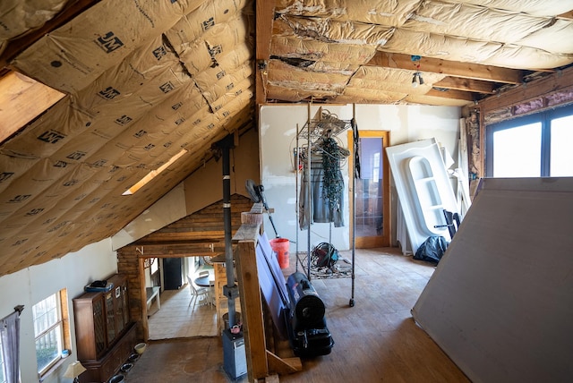 interior space with hardwood / wood-style floors and vaulted ceiling