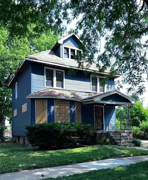 view of front of home with a front yard and a porch