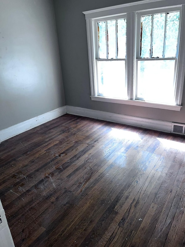 unfurnished room with dark hardwood / wood-style flooring