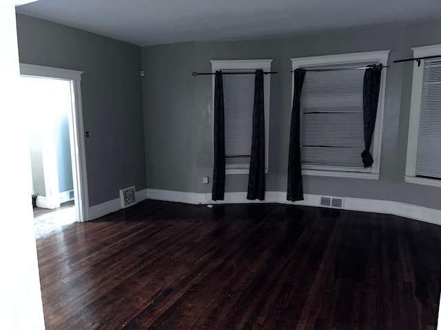 spare room featuring dark wood-type flooring