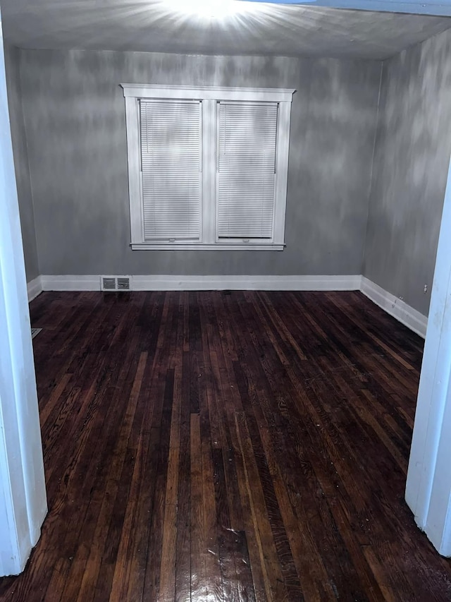 spare room featuring dark hardwood / wood-style flooring