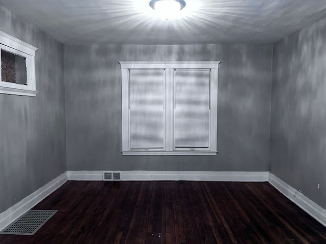 empty room featuring dark hardwood / wood-style flooring