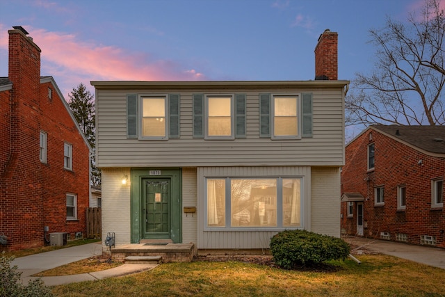 front facade with cooling unit and a yard