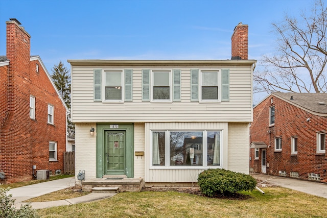 view of front of home featuring central AC unit and a front lawn