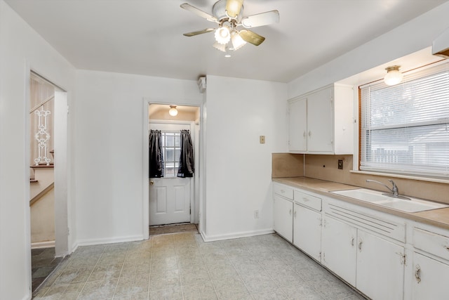 kitchen featuring sink, ceiling fan, white cabinetry, and tasteful backsplash