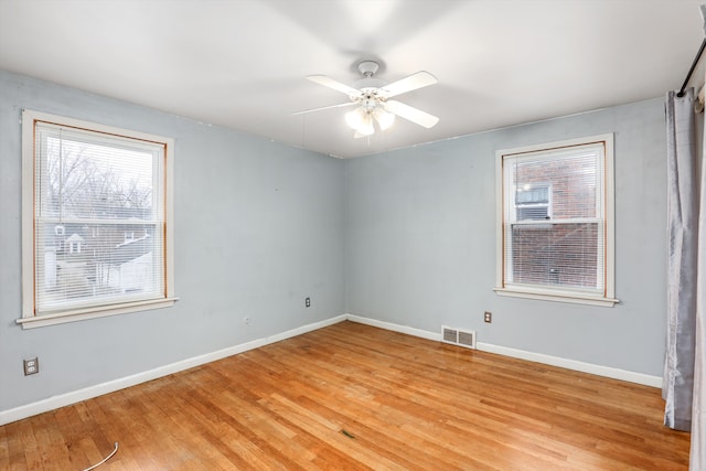 spare room featuring ceiling fan and light hardwood / wood-style flooring