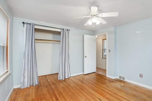 unfurnished bedroom with ceiling fan, light hardwood / wood-style flooring, and a closet