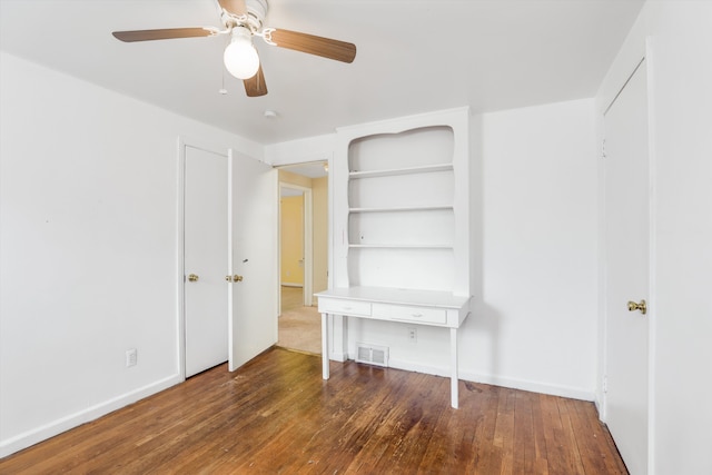 unfurnished bedroom with dark wood-type flooring and ceiling fan