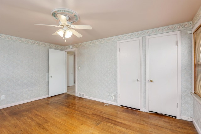 unfurnished bedroom with ceiling fan and light hardwood / wood-style flooring