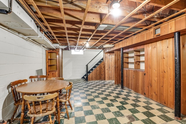 basement featuring wood walls