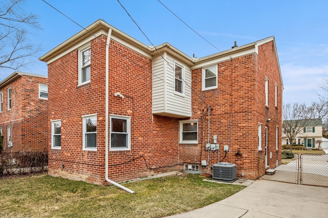 view of home's exterior with central AC unit and a lawn