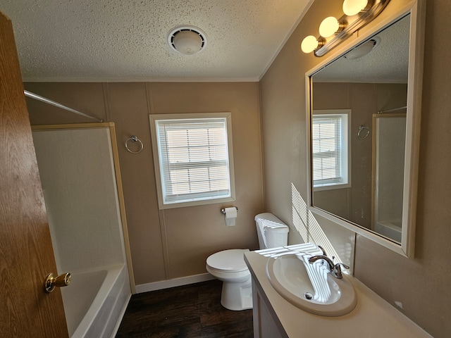 full bathroom with crown molding, a textured ceiling, toilet, vanity, and hardwood / wood-style flooring