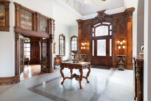 foyer with a high ceiling and ornamental molding