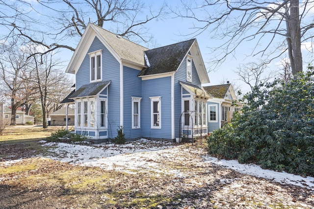 view of snowy exterior with a sunroom