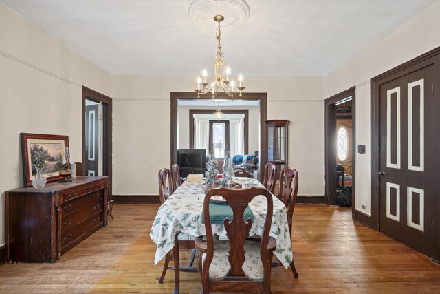 4851 Dowling St, Montague, MI 49437 - dining room with light wood-style flooring, a chandelier, and healthy amount of natural light