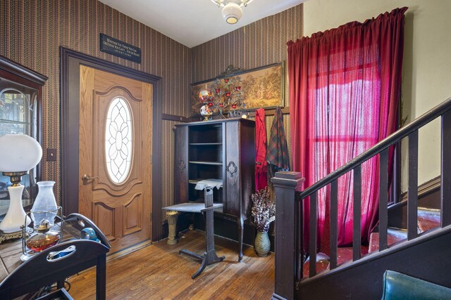 4851 Dowling St, Montague, MI 49437 - entrance foyer featuring wallpapered walls, stairs, and wood finished floors