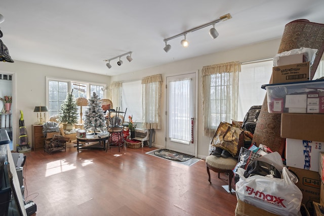 interior space with hardwood / wood-style flooring and rail lighting