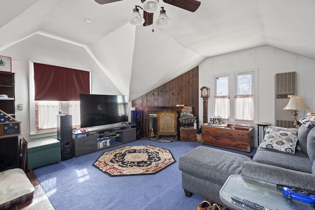 living room featuring ceiling fan, wooden walls, and vaulted ceiling