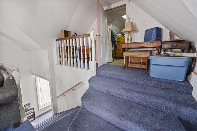 stairway with carpet and vaulted ceiling