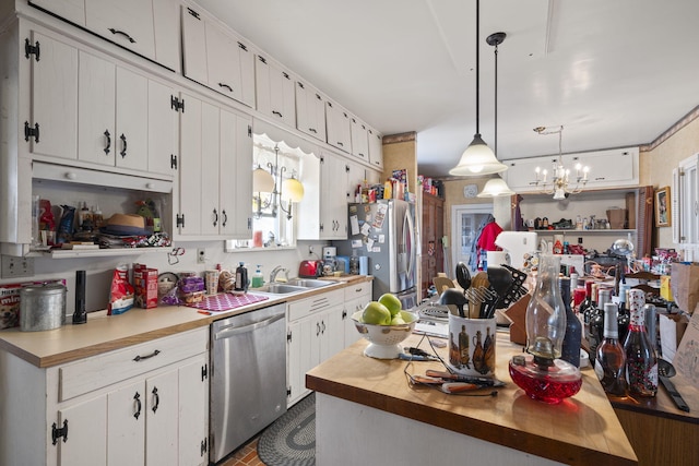 kitchen with pendant lighting, white cabinets, and appliances with stainless steel finishes