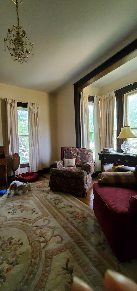 interior space featuring hardwood / wood-style flooring, plenty of natural light, and a notable chandelier