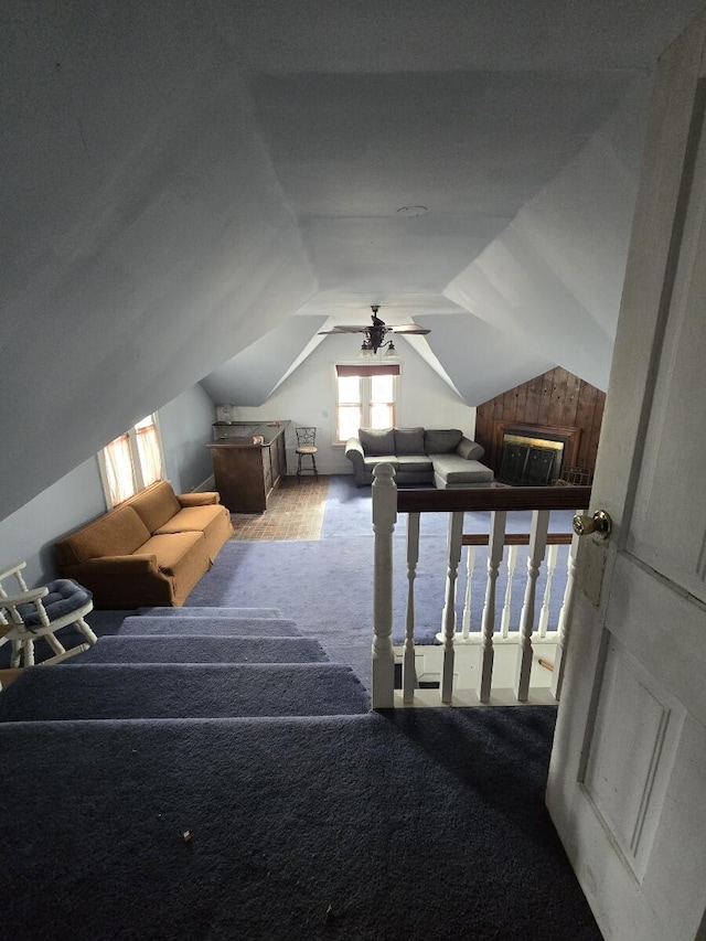 additional living space featuring carpet floors, a ceiling fan, and vaulted ceiling