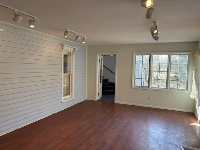 interior space with rail lighting, stairs, and wood finished floors
