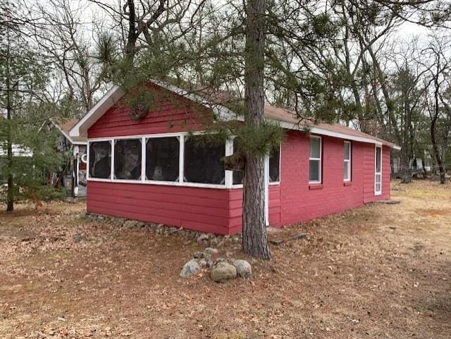 view of side of property with a sunroom