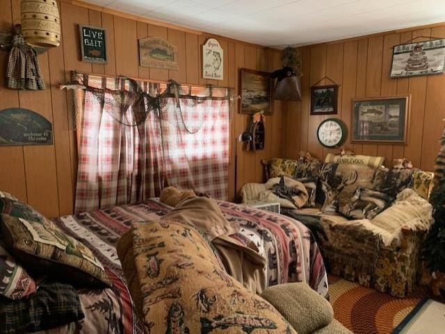 bedroom featuring wooden walls