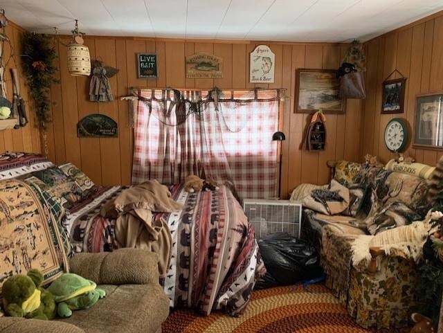 miscellaneous room featuring wood walls