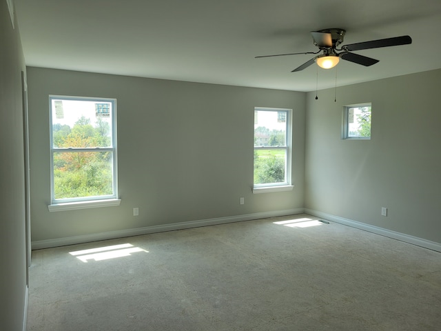 unfurnished room featuring ceiling fan and light carpet