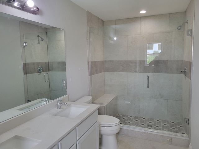 bathroom with an enclosed shower, vanity, and toilet