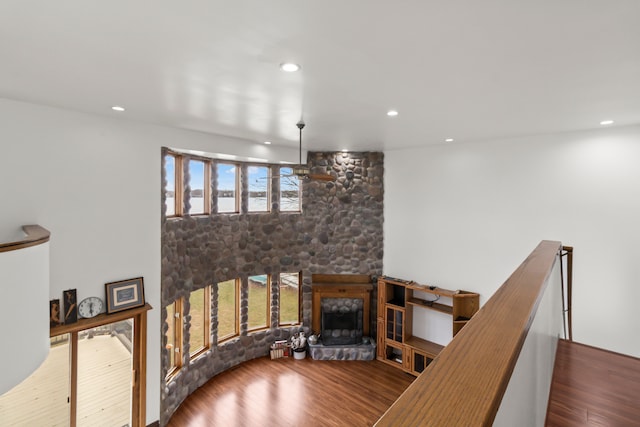 living room featuring a wealth of natural light, a fireplace, and wood-type flooring