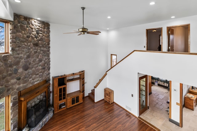 living room with a fireplace, hardwood / wood-style flooring, and ceiling fan